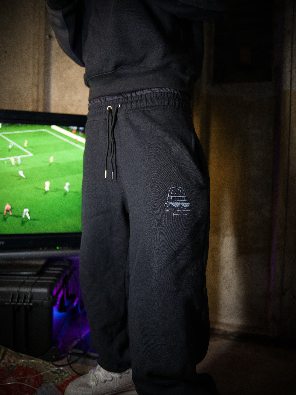 Parkside black joggers — embroidered thigh graphic beside the FIFA screen