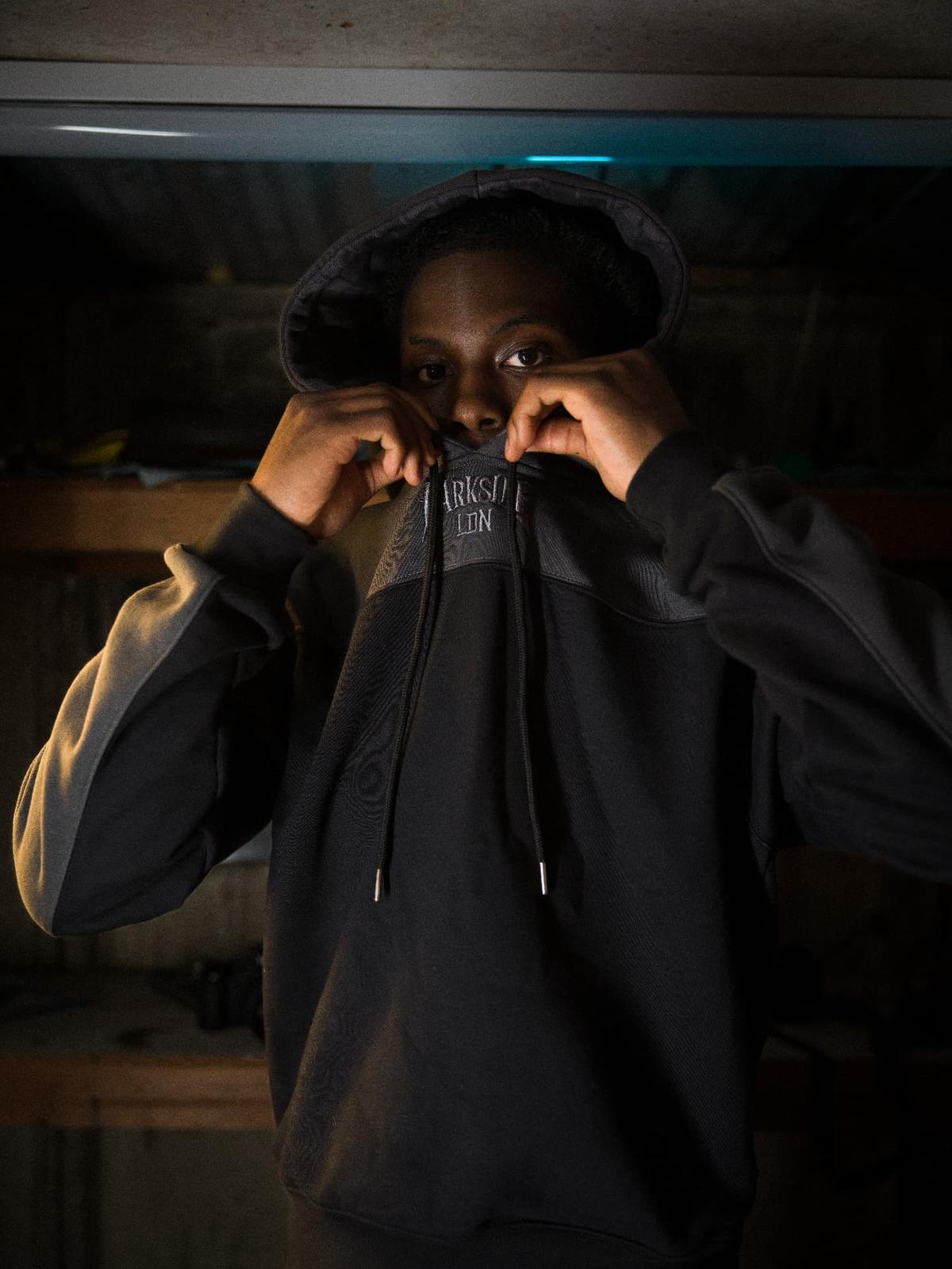 Parkside black hoodie — hood up, embroidered chest detail